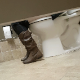 A daring cameraman stands in a public restroom stall at a Chipotle restaurant and records a girl wearing glasses and boots pissing and trying to take a shit in an adjoining toilet stall. No pooping sounds heard. Vertical format video. About 3.5 minutes.